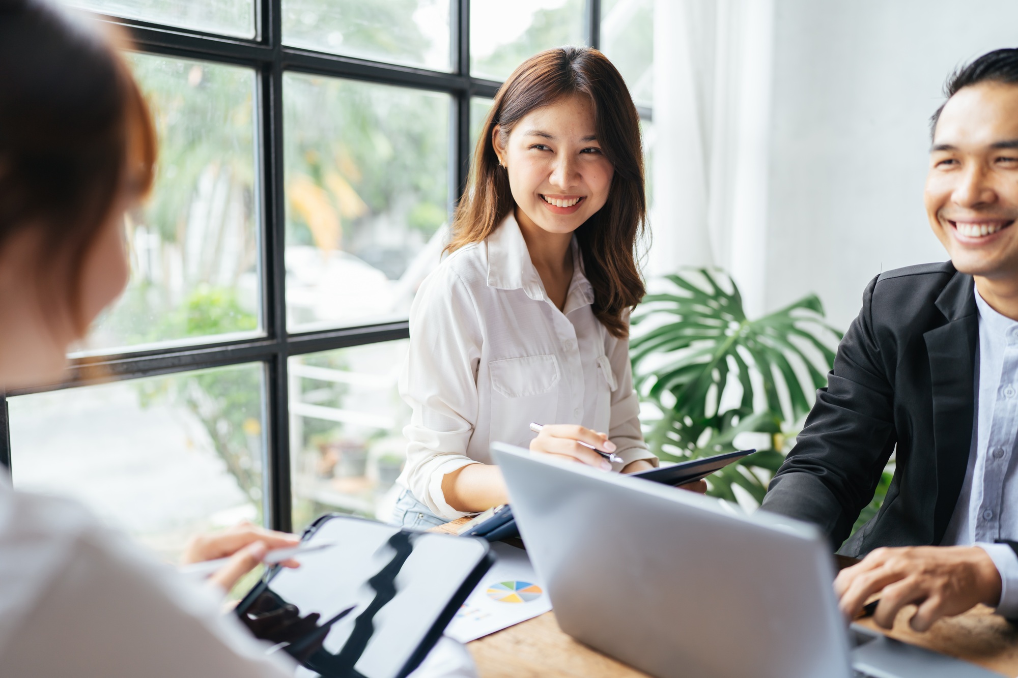 Asian business woman present and explain work to female colleague