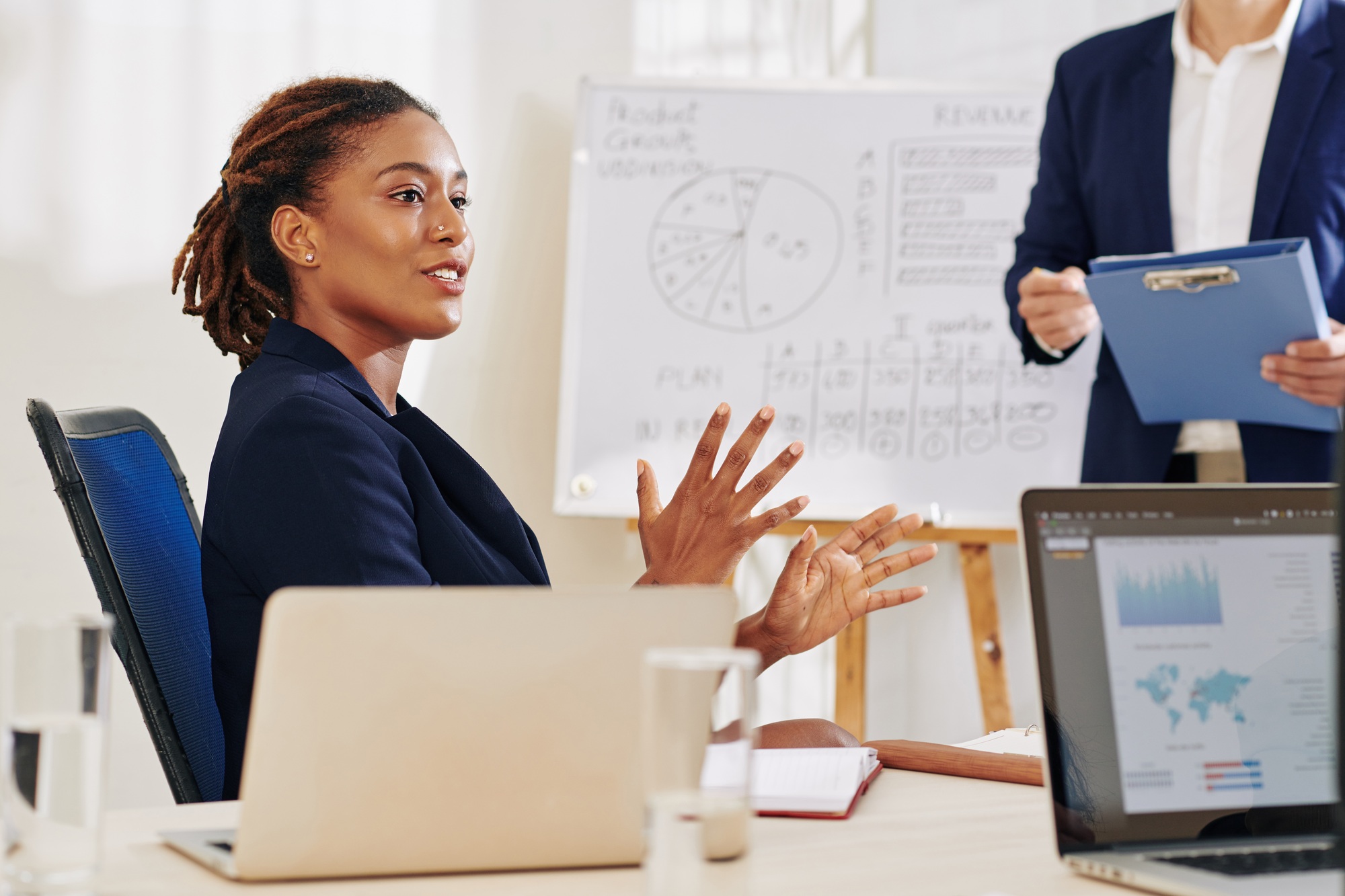 Businesswoman explaining idea to colleagues