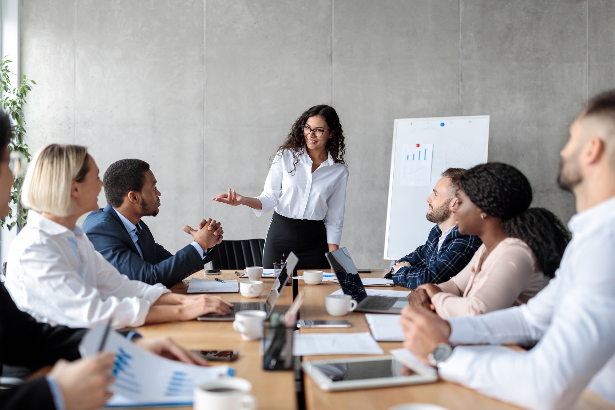 Businesswoman Making Business Presentation For Colleagues In Modern Office