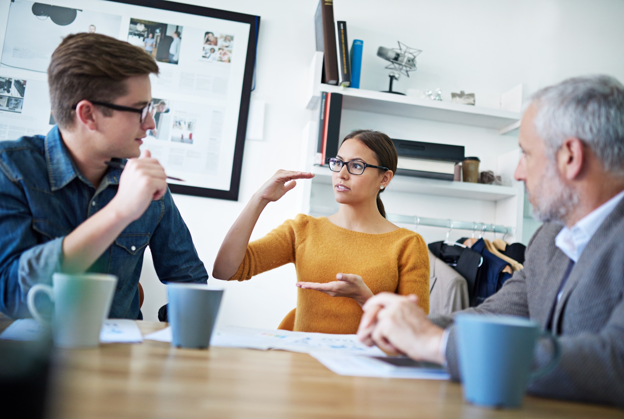 Shot of a young businesswoman explaining something to her colleagues in a meeting